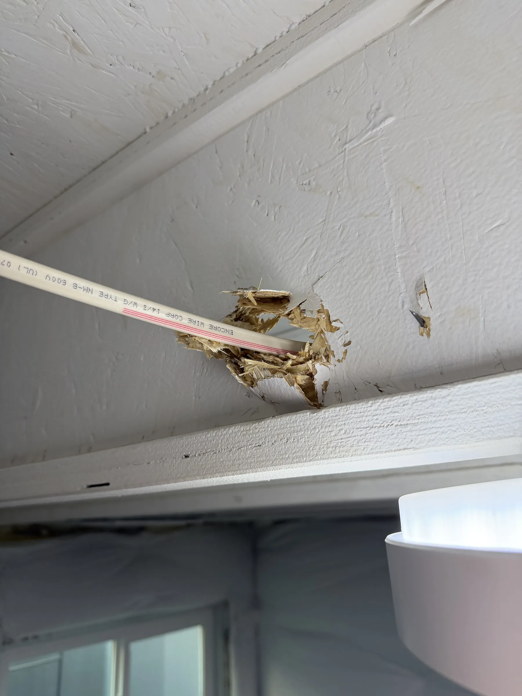 Wire coming out of overhead gym light. Hell of a hole they drilled here.