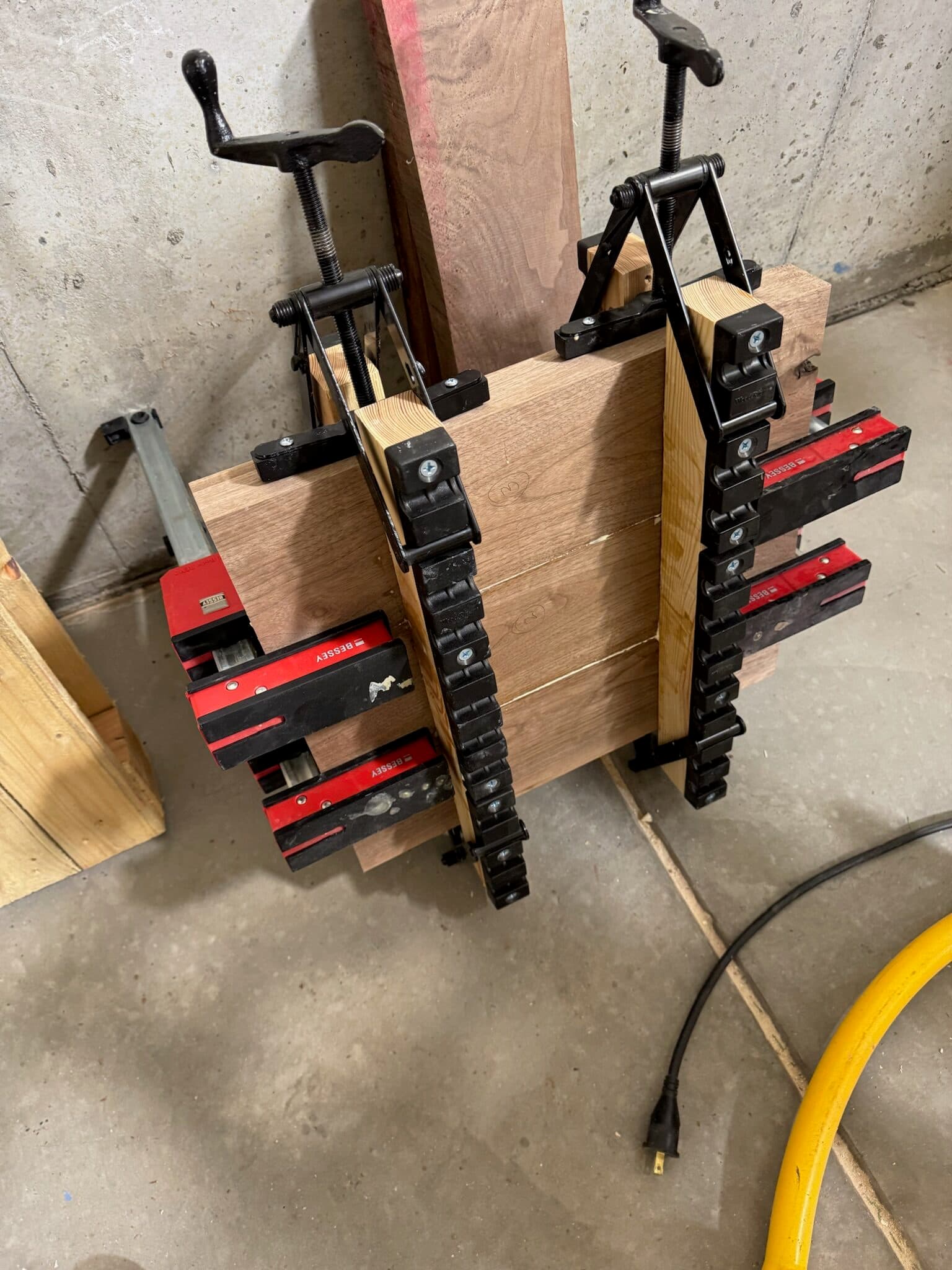 Walnut body blank held together with parallel clamps