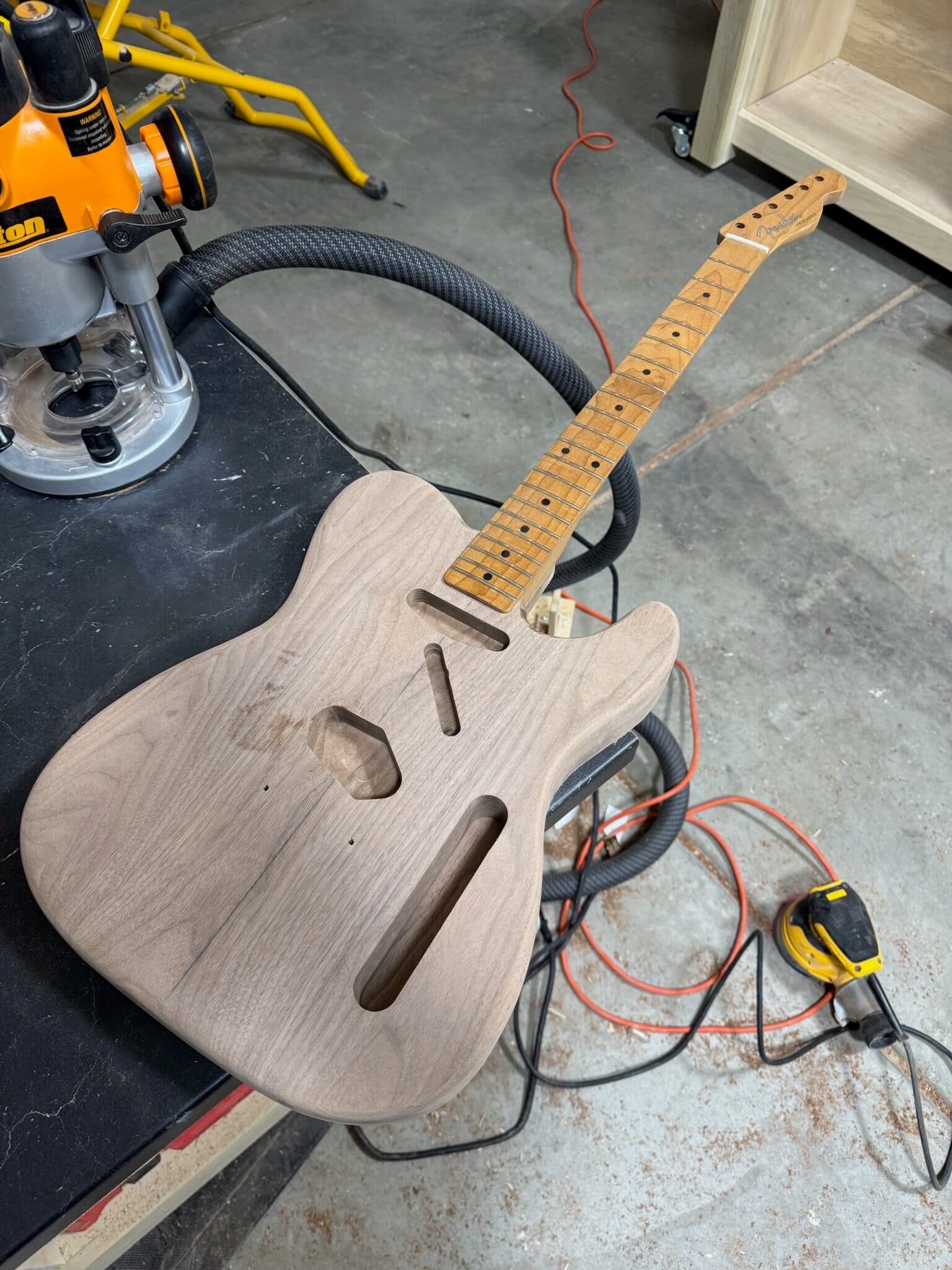 Dry fitting the maple neck and electronics to the walnut body